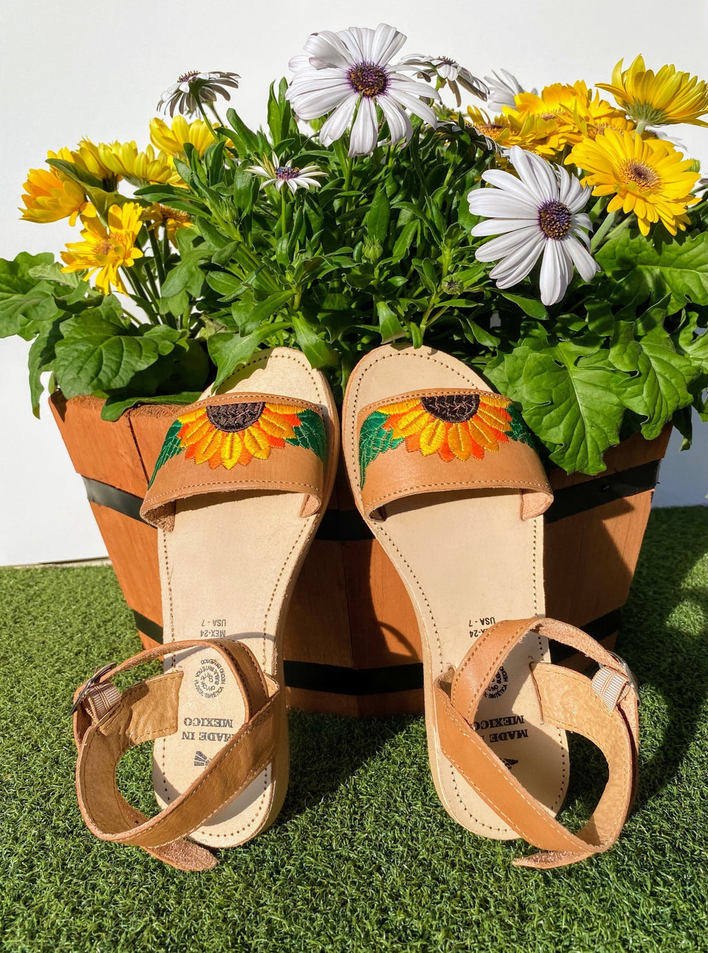 Women open toed huarache sandals with buckle strap and embroidered sunflower design.